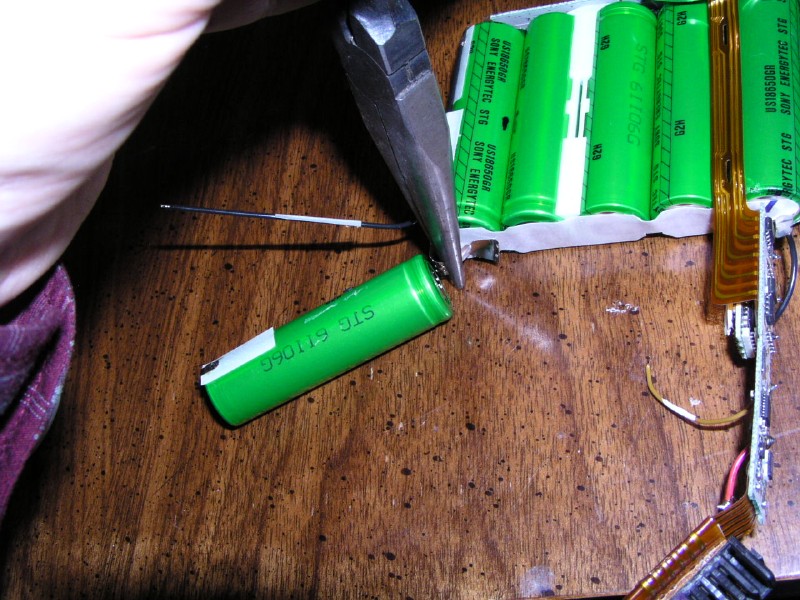 Removing a solder tab using pliers.
